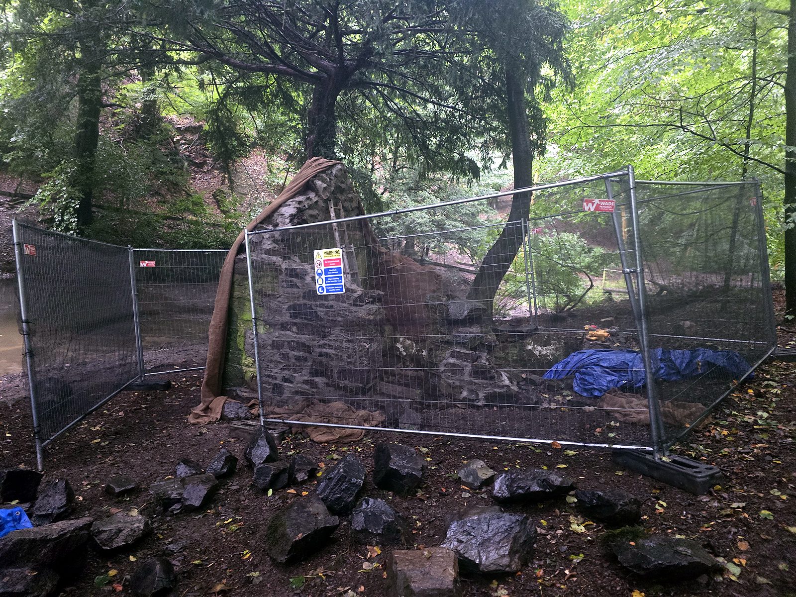 The Pump House fenced off with stone ready for rebuilding
