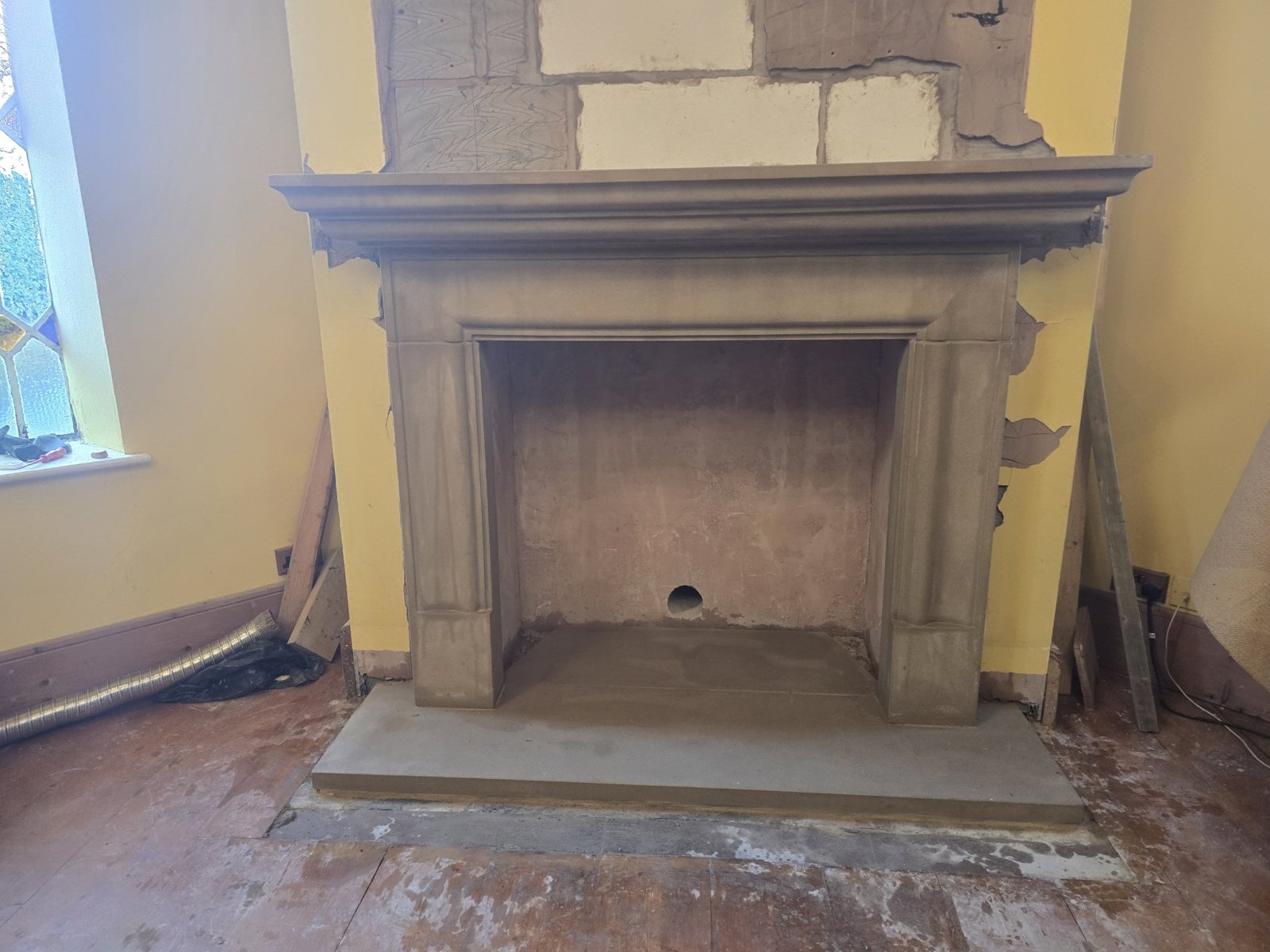 A stone fireplace surround fitted during renovation work