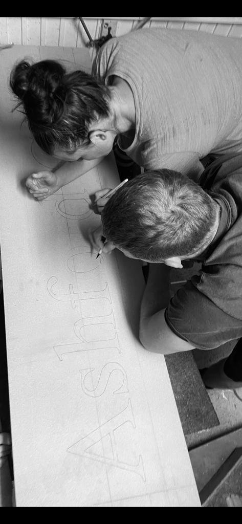 Setting out and cutting lettering by hand on a long stone