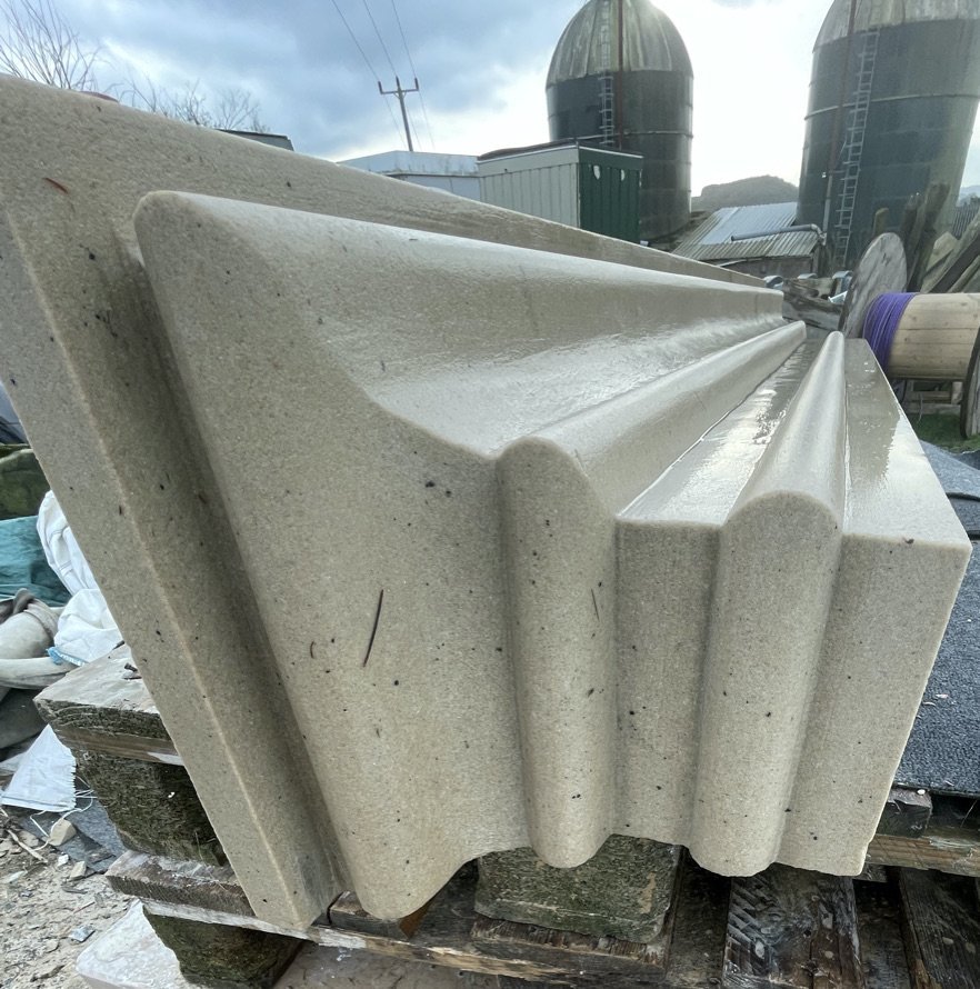 A moulded stone piece in the yard, showing the hand-worked profile