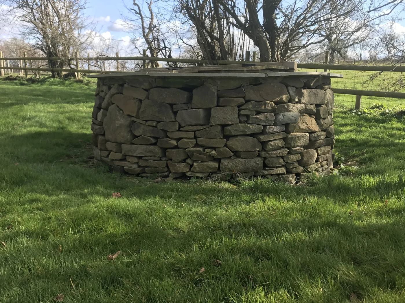 Dry stone walling over a well at Jinlye guest house